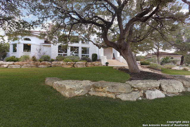 This prestigious estate sits on just over 5 acres in Cordillera Ranch, where the home's owner will enjoy living in the Hill Country's most exclusive master-planned community boasting the very finest in resort-style living. [MASTER GOLF MEMBERSHIP] is available to the next owner.] An entertainer's dream home, it features a ballroom-sized living room with soaring 23-foot ceilings and abundant natural light.  The massive and ornate double-sided fireplace is enjoyed from both this room and the large dining room where guests can enjoy the covered patio featuring a separate shade trellis and manicured landscaping.  The kitchen features an oversized leathered granite island where conversations are held, while the chef enjoys cooking on a 60-inch BlueStar 6 burner cooktop with a griddle and double ovens.  The separate refrigerator and freezer are by Sub-Zero. The pantry has plentiful shelves for storage, and 41 slide-out drawers for even more storage! You must see this home to understand how special it is... from the 14-foot front doors imported from a church in Argentina to the hand-laid mesquite wood flooring, plus the office adorned with custom shelving and a wet bar.  The owner's suite features two full and separated bathrooms, each with its own large closet spaces.  All guest rooms have their own attached full bathroom. If you are a discerning home buyer searching for an estate rich in heritage and the finest finishes, 550 Cordillera Trace is a home you MUST consider.  You are encouraged to set your appointment to experience it soon.