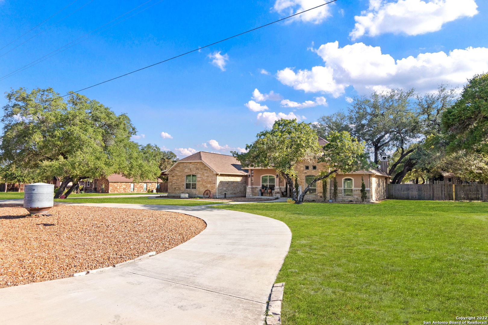This stunning custom home is located in a highly desirable community and is a must see! The property sits on over an acre of mature oak trees, has rock landscaping, and   features a roundabout drive way, perfect for guest use. Recently installed, a Rainbird sprinkler system is located in both the front and back yard. In addition, a large 28X40 metal shop, built in November 2019, features a 26' overhang/carport, a vast amount of space, drive through garage doors, and electricity both inside and out. Fully upgraded throughout: The home opens to an spacious, open concept floor plan and features abundant natural lighting throughout. The upgraded cabinetry, massive granite countertops, beautifully designed rockwork, and upgraded appliances make this kitchen a home chef's dream! Spacious bedrooms feature high ceilings and walk in closets. The spa like master bath illuminates what it means to relax with it's garden tub, large walk in shower, and dual vanities. Relax fireside on your extended covered patio or take a dip in your custom 27' stock tank pool, the features are endless!      *Agent is married to seller