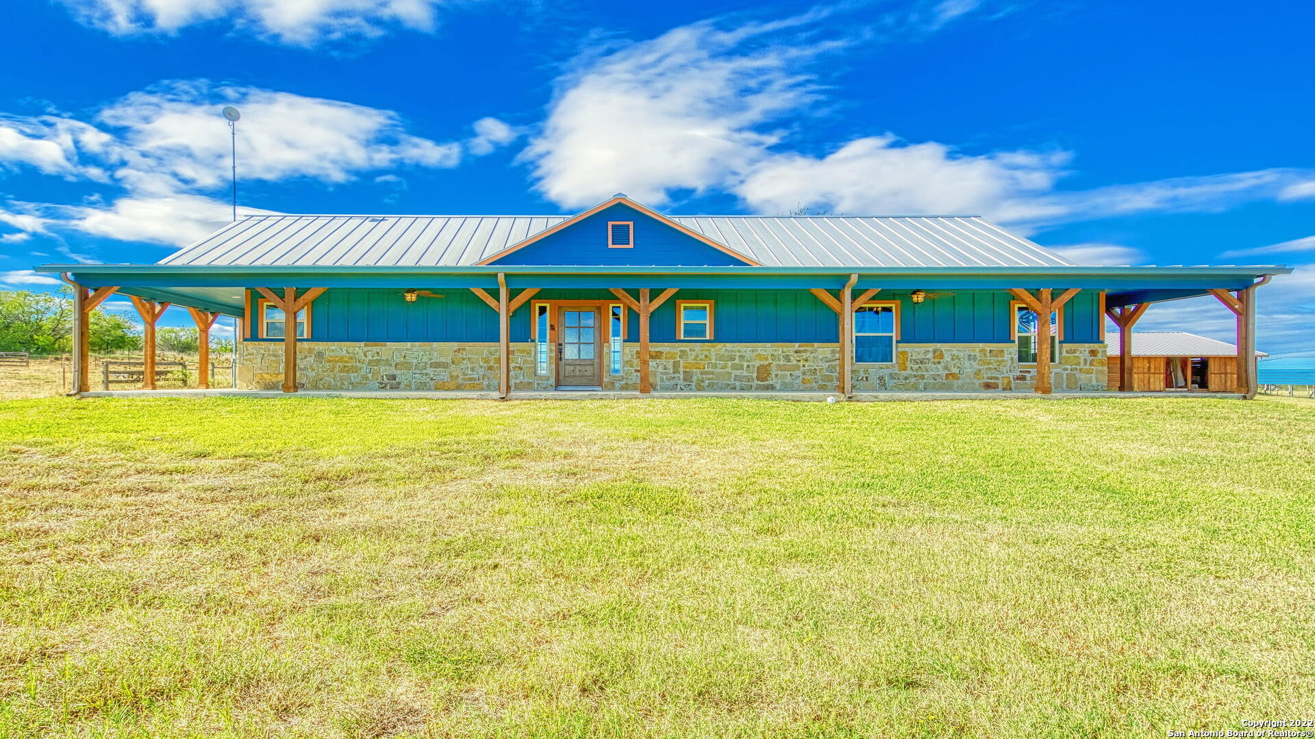 Ranch style home on 10 acres just minutes from Floresville, Stockdale, and Sutherland Springs! Built in 2019, this 2252 sq ft home has a split floor plan with an open island kitchen, living room, and dining area.  Kitchen includes corner sink, all granite counters, disposal, SS refrigerator, stove range, microwave, dishwasher, and walk in pantry that includes another small refrigerator.  Home offers a master suite that includes access to the covered back porch through a bonus area that would make a great exercise area or home office.  Master bath offers large walk in closet, large tile shower, separate his and hers vanities, and private potty room with bidet.  Located off the living room is another bonus room and the utility room which includes washer, dryer and water softener (ALL APPLIANCES ARE INCLUDED!).  Located on opposite side of the house lies the additional 2 bedrooms and full bath with tub/shower and double vanity.  Home has ceramic, wood-looking, tile floors throughout.  Did I mention the home has a porch that wraps around 3/4 of the home!  Got horses? This property has a large horse barn (35X71) with 5 stalls and room for more!  Also has additional storage building (12X12), carport (20X24), and a foaling shed (12X24).  Property is fenced and crossed fenced.  Property includes 2 septic systems, 2 electric meters, and 2 water meters. COUNTRY LIVING AT ITS BEST!! CALL TODAY!
