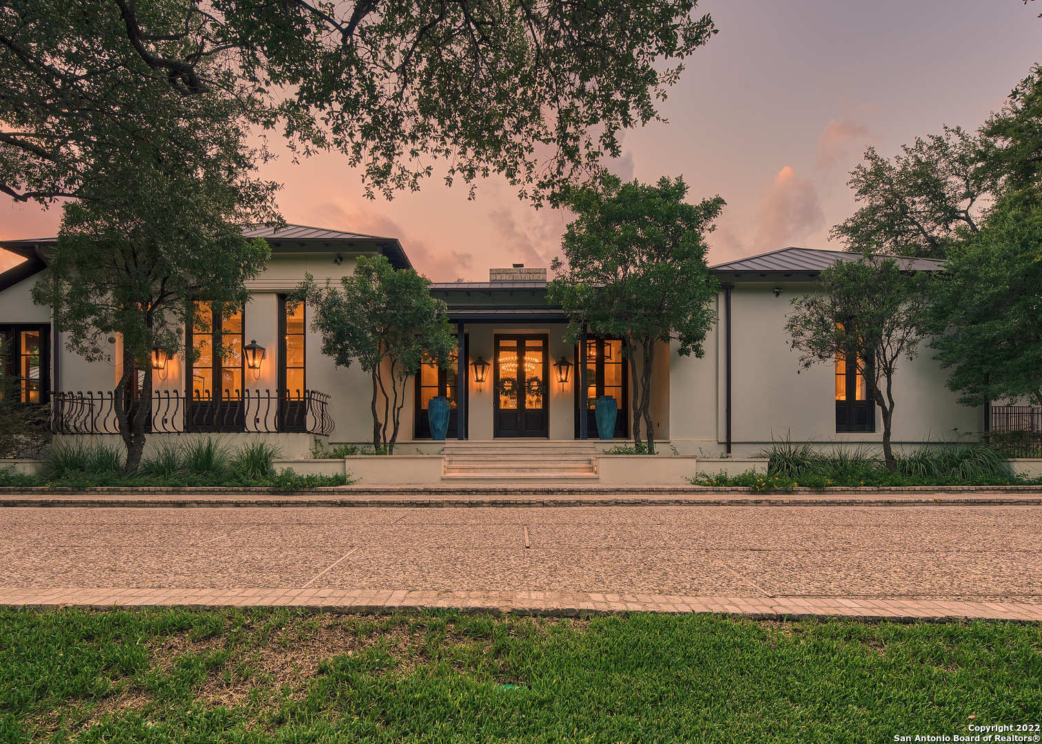 Secluded in a parklike setting on just over an acre, this stunning Contemporary Mediterranean showpiece perfectly exemplifies the luxurious privacy and convenience. Designed by renowned architect Don B. McDonald, the home is graced by a spacious open living room, gourmet island kitchen, spa-like primary suite and a private library with a hidden room. The current owner, one of San Antonio's best designers, has refreshed and reimagined the space to the last detail, including bespoke copper lighting, imported materials & restored antique hardware. The outdoor entertaining area showcases a fully fenced pool, infinity edge spa, covered patio, fireplace & kitchen.