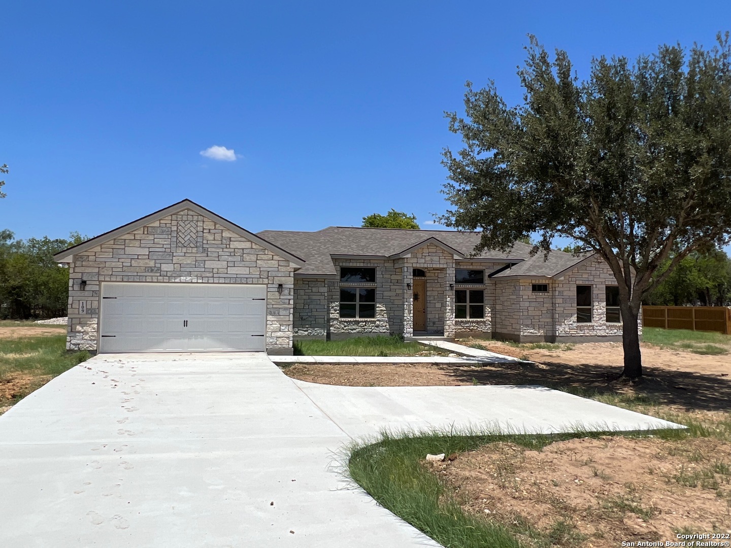 Beautiful new home in The Granberg on a .73 Ac and just 30 minutes from downtown San Antonio. **END OF YEAR PROMOTION closing by December 31st and get $25,000 Towards closing cost**. Enjoy the high ceilings on this 3 bedroom and 3 bathrooms with a very functional floorplan with lots of natural light and no steps, no carpet, just tile throughout the property.  Also included a smart home security system. Master suite is nicely sized with a large walk in shower and walk-in closet. Nicely sized kitchen with solid countertops & stainless steel appliances and large pantry.