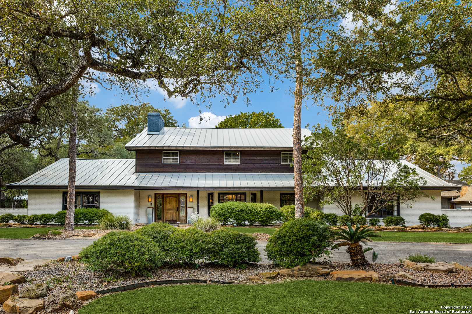 Take advantage of this rare opportunity by Landa Park on "The Hill" near downtown New Braunfels! Luxurious country living can be found within this five-bedroom, three-and-a-half-bathroom home located on a corner lot in one of New Braunfels most coveted neighborhoods. Although this home features many modern features, it still holds some of its unique '60s features, such as rockwork and wood-lined office space. Within this 5027 sqft home, you will find multiple living and dining spaces inside and an exquisite backyard with a large, covered patio and in-ground pool. This space is ideal for those who love to entertain. Property also includes a detached 3-car garage and a spacious, climate-controlled work room. Additional structures are a climate-controlled storage building and a greenhouse. Schedule your private showing of this exquisitely designed New Braunfels home; photos do not do it justice!