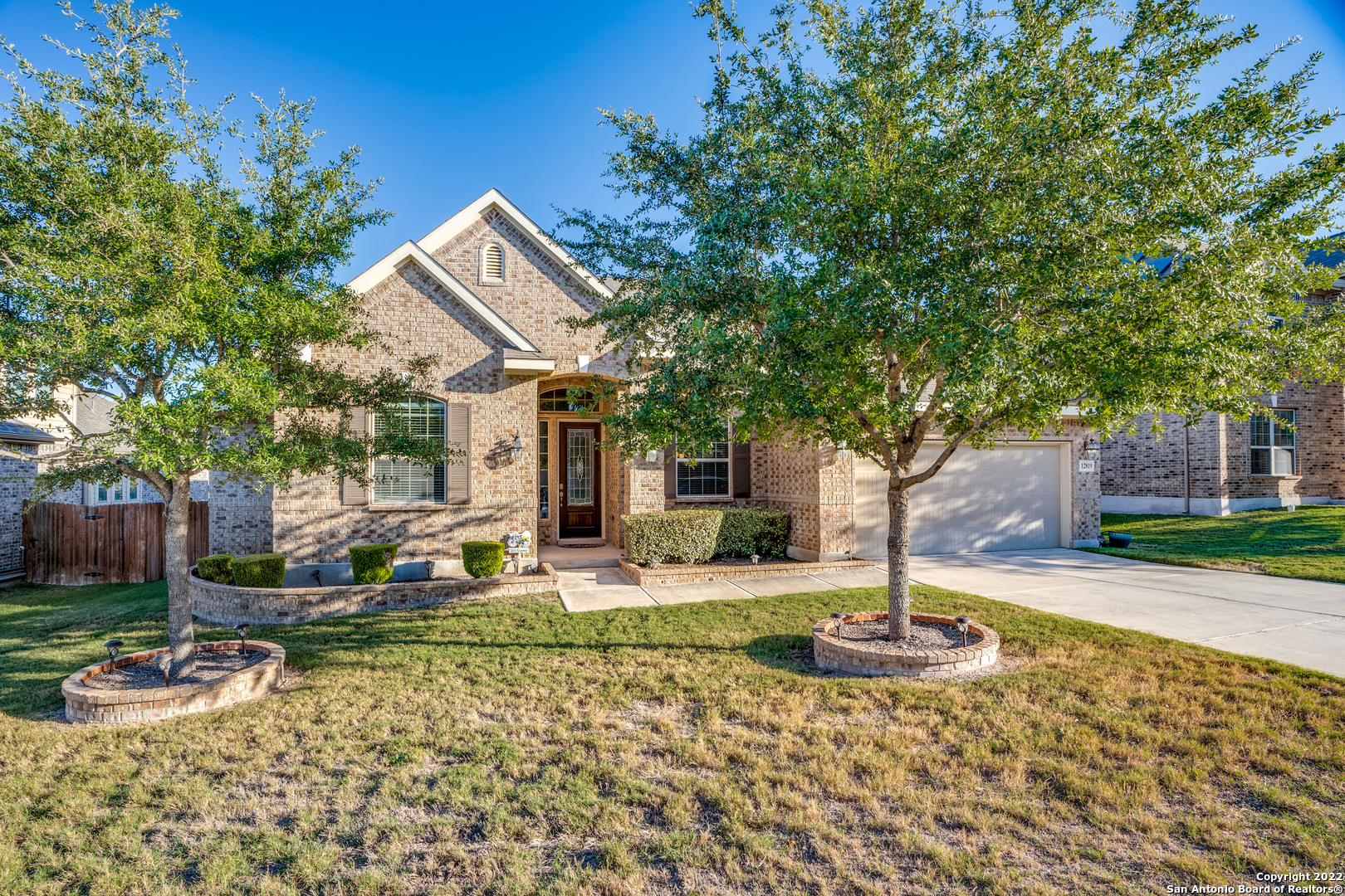 Stunning single-story home in the prestigious Summit at Alamo Ranch gated community ready for move-in! Conveniently located near Loop 1604, Loop 410, Seaworld, and plenty of shopping and dining. Original owner has maintained the wonderful curb appeal and high-quality interior for you to enjoy. Spacious floor plan provides a generously-sized dining room upon entry - perfect for holidays - and a private study with French doors. Light-filled living room with ceramic flooring offers a beautiful enclosed stone fireplace, backyard views, and outdoor access. Abundant natural light flows throughout the home with arched entryways and soaring ceilings! Open kitchen features extensive cabinetry, gas cook top, built-in oven, walk-in pantry, breakfast nook, and stainless-steel appliances. Master suite has its own private bath with walk-in shower, a whirlpool garden tub, separate vanities, and roomy walk-in closet. Outdoors, find a charming, fully covered flagstone patio with ceiling fans and added pergola- truly a backyard oasis!