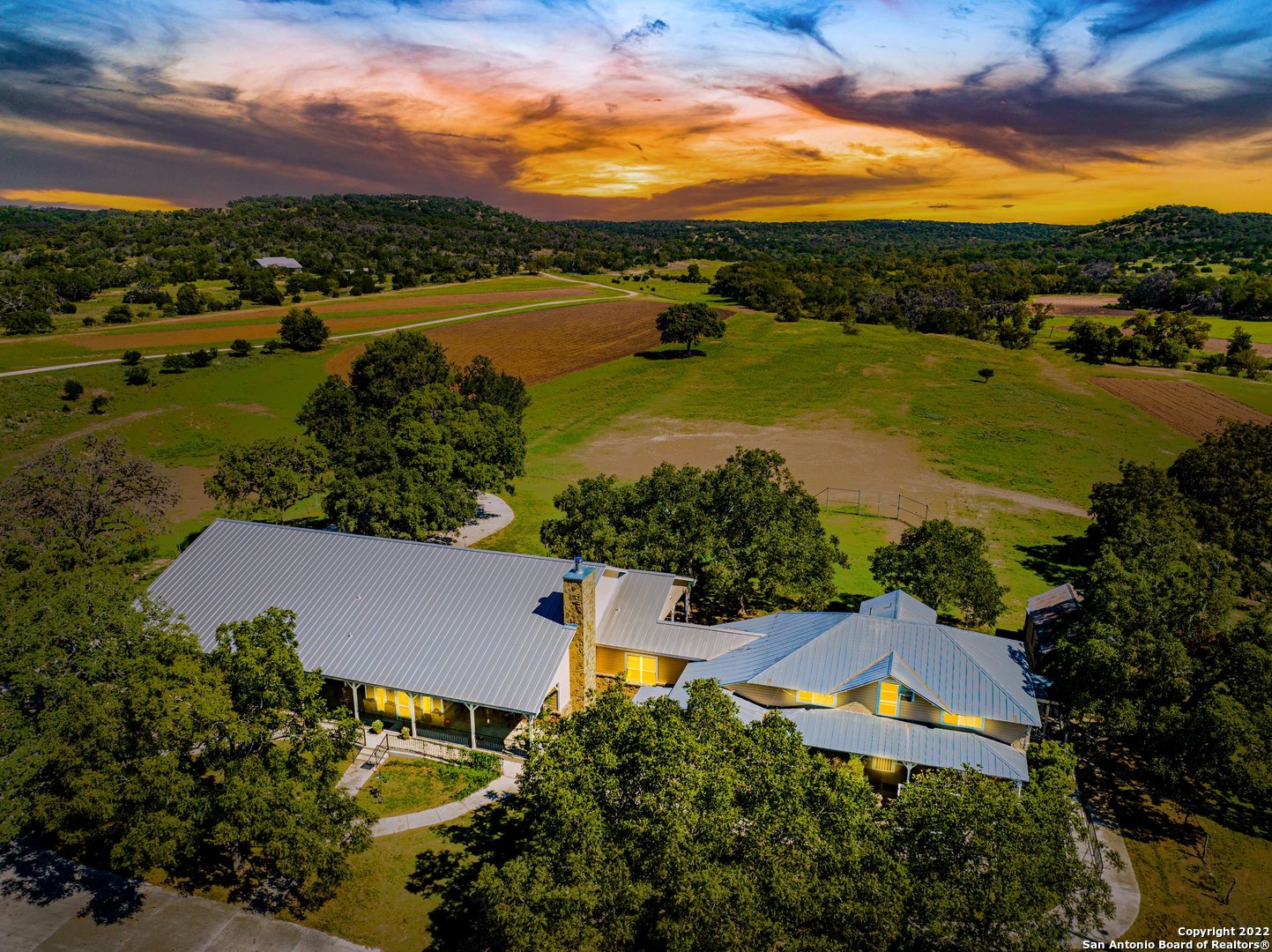 This is a one of a kind property in an amazing location situated just minutes away from Fredericksburg and the epic Texas wine corridor. Old #9 Hwy in historic Comfort...from the moment that you step on this beautiful property you experience the Texas Hill Country at its best! Enjoy spectacular views from high elevations. This property also features level, open cultivated fields surrounded by Live Oak, Pecan, Black Walnut and Sycamore trees. Year-round Block Creek runs through this property and provides a semicircle waterfall surrounding your very own "swimming hole". A deep gunited area of the creek is the perfect place to enjoy a summer day. There is an unnamed spring that runs for approximately 1,980 feet through the property with a spring box. This property features an original home that was built in the 1920's which has been completely redone and updated. A new home was built in 2013 featuring high ceilings, large fireplace in the great room, and has been fitted as handicap accessible. There are multiple barns, shops, and covered areas. Historic old structures remain and add to the unique ambiance of this historic property. Chandelier in new dining area does not convey.
