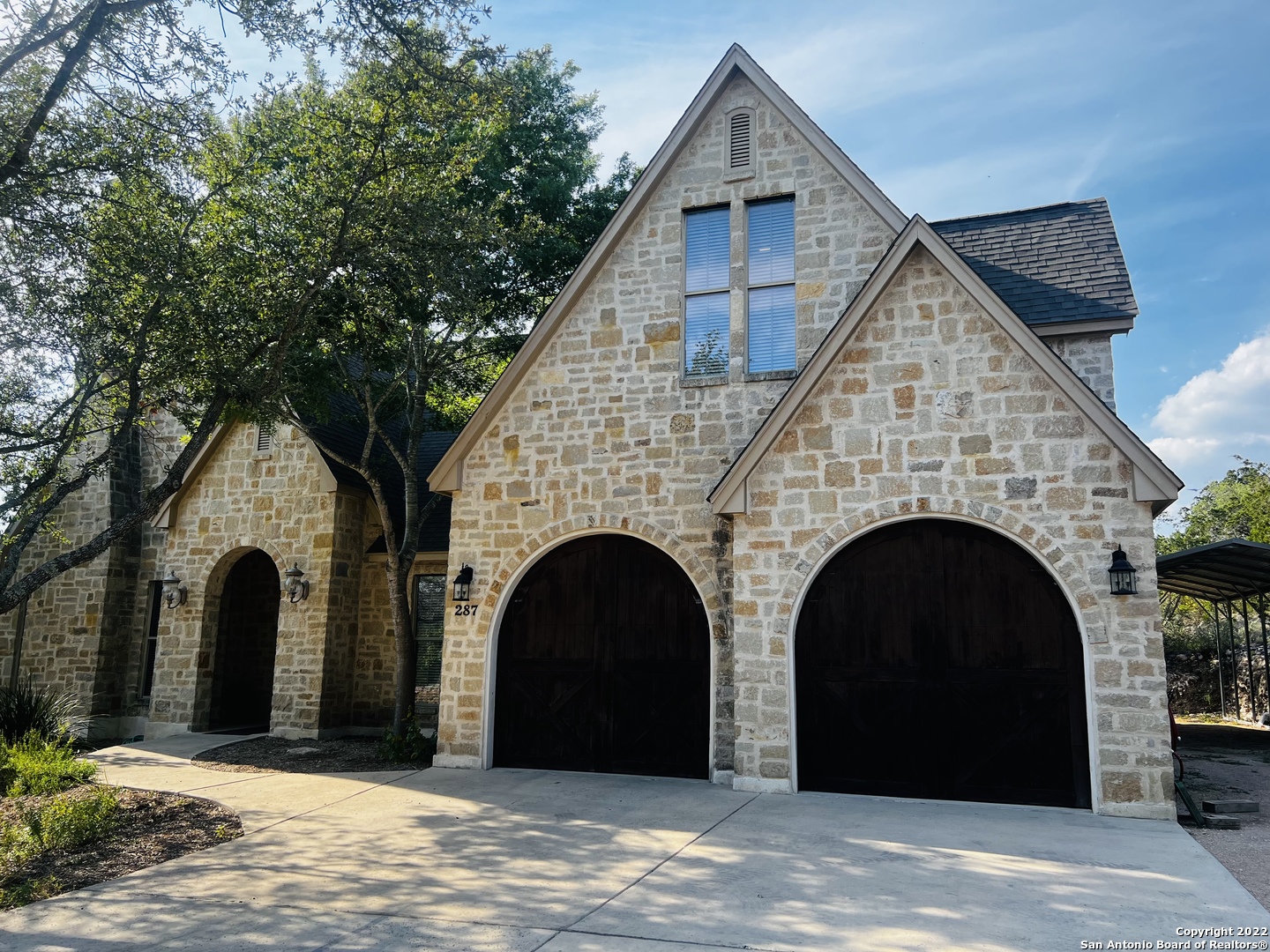 Motivated Sellers! Talk about location! This beautiful custom home sits on 2.58 acres in the gorgeous hill country setting of Laurel Canyon Ranch. The left side of the property is next to a Greenbelt with a wet weathered creek. A one of kind home that offers unique features inside and out while nestled in a community with a 10mile walking trail along a nature preserve. While the properties here have acreage with plenty of privacy, the LCR community participates in family picnics, hayrides, movie nights and many other neighborly gatherings. Venture into the fabulous stained concrete flooring with open concept kitchen and living room and a view of the pool, enjoy the well-crafted layout of the primary bedroom on one side with secondary rooms on the other, stairs to the second story made from Red Oak, upstairs boast a huge bonus/loft room that could be a 4th bedroom (has enough space for 2 bedrooms if you wanted) with a half bath (plenty room for guest accommodations), 2 fireplaces in the home, two-car double bay garage that is deep enough to fit 4 autos, approximately 1200 sqft patio space for entertaining, 50 amp RV hookup installed, a solid wood custom entry, cedar garage doors, and much more! Country living with a short 3 miles drive to Medina Lake, easy access to San Antonio and Bandera. Come experience this little kept secret of a gem before someone else does.