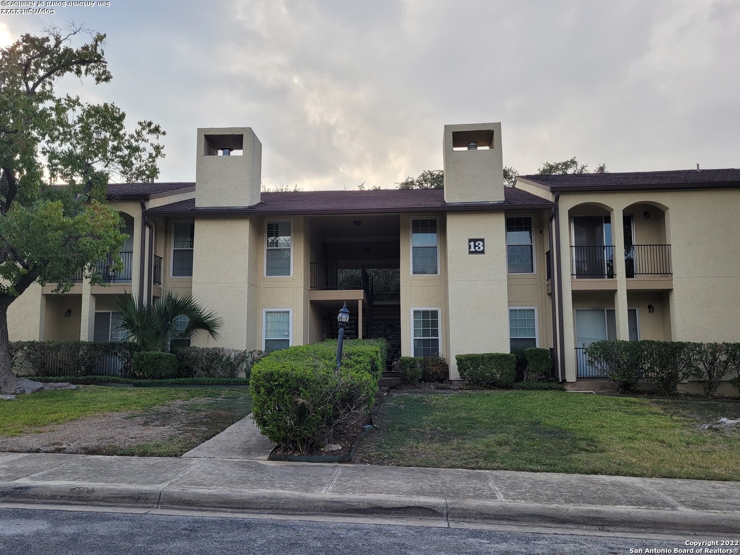 Rare opportunity to buy a 3 bdrm-2 bath condo within walking distance to Northeast Baptist Hospital and bus line! Condo overlooks the tree shaded 2-car carport; Bldg 13 is next to office and mailroom; enjoy the clubhouse; unit has no carpet; enjoy the living/dining room with wetbar, hardwood floor and wood burning FP; unit is on 2nd floor and shaded by tall oak trees; kt/bk has ceramic tile floor; kt features solid counter tops, ref., smooth cooktop range; washer & dryer in master bdrm WIC closet; 2 balconies! tree shaded 14x6 balcony off LR/DR; front bdrm with 11x5 balcony; on site management!