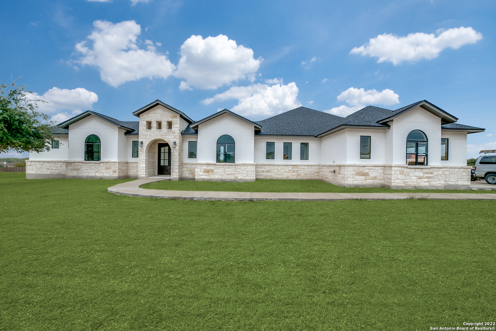 This gorgeous, custom-built home has recently been built with modern finishes and a floor plan built for entertaining. Upon arrival, the striking stone exterior welcomes guests before entering through the majestic arched entry. Through the dedicated entry, soaring ceilings are accented by picture windows and an immaculate interior color palette. The spacious open floor plan showcases a stunning floor-to-ceiling electric fireplace with tile accent in the living space. The gourmet kitchen is sure to be a chef's vision with ample white cabinetry and contrasting hardware. The center island will also be suitable for bar seating. The spacious dining will host plenty for holiday gatherings and more. Retreat to the luxurious primary suite with natural lighting and a spa-like en suite with a walk-in closet designed for a shopaholic. Three secondary bedrooms and an office space complete the interior. Convenient to neighborhood amenities including a play area and enjoy views to the small lake , come see this stunning property today!