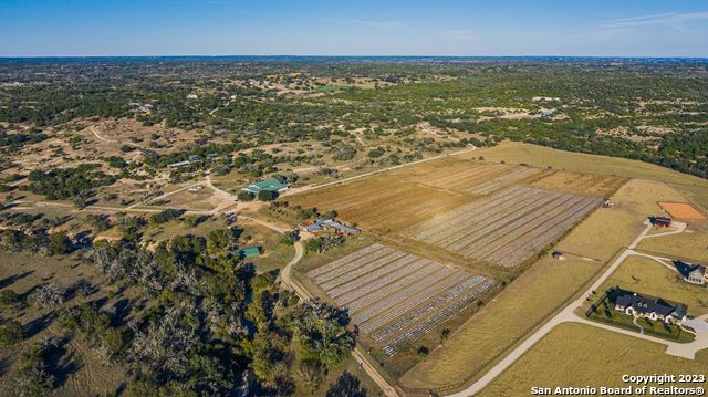 Just 12 miles from Fredericksburg, TX, this former winery is comprised of a large building and 18.16 of unrestricted acres of land in the Texas Hill Country AVA. This is the perfect location for a winery, farm-to-table restaurant, event center, glamping outfit, distillery, brewery or agrotourism destination. This property offers 18.16 AC and 13,276 SF winery/retail/office building, improved pasture with 1,872 SF of barns, storage, two water wells and two septic systems. This unrestricted tract is perfect for a vineyard, organic gardens, a berry-picking farm, safari, petting zoo, or whatever you can dream up (TRACT 1). Additional features include a parking field to accommodate 50 or more vehicles. The building's interior offers a large wine production area, complete with water and floor drains, that is also well suited for other uses such as a distillery and/or a brewery. There are a number of offices and plenty of storage and meeting spaces available. An area for culinary experiences is available through the kitchen, which features a wood-fired pizza oven for making gourmet, handcrafted pizzas. The saloon-style tasting room awaits with plenty of space for quietly enjoying a glass of wine or hosting large gatherings. Outside, a covered porch provides views of the stunning Texas Hill Country along with a space for playing horseshoes. There are also two adjacent additional tracts containing 15 AC improved pasture (TRACT 2) and 27.5 AC live water acreage (TRACT 3) that are available for purchase.