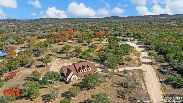 This 17.13-acre unique Boerne property features two homes and a commercial office building totaling 9,365 square feet! * NO HOA * As you enter the entry gate, you'll find the original home nestled along the ravine with a gorgeous treelined view. This rustic home built in 1900 is approx. 1774 square feet with a full bedroom and bathroom downstairs and a loft style bedroom & full bath upstairs. As you continue through the property, you'll pass the creek area. This has been full of water since 2011 and dried out this year for the first time (virtually enhanced photo to show with water). The 2nd home is just past the creek with views for miles! This 4,531 sq ft one story home is custom built by Tilson and offers the Owners suite and two secondary bedrooms on the first level and the 4th bedroom, media room and game room / loft on the second floor with the third full bath. The 3,060 square foot office building was built in 2019. This office space is bright and airy and has beautiful windows and woodwork throughout. Additionally, there are two metal structures for animals, two tuff sheds, a green house and a playhouse which can be removed or convey with the sale. The 4-car garage shop is 30X50 with roll up doors. The property includes two water wells, two (2) 5,000-gallon water storage tanks and one 1,000 gallon storage tank.  1.54% Kendall County tax rate! This beautiful hill country oasis awaits its new owner!