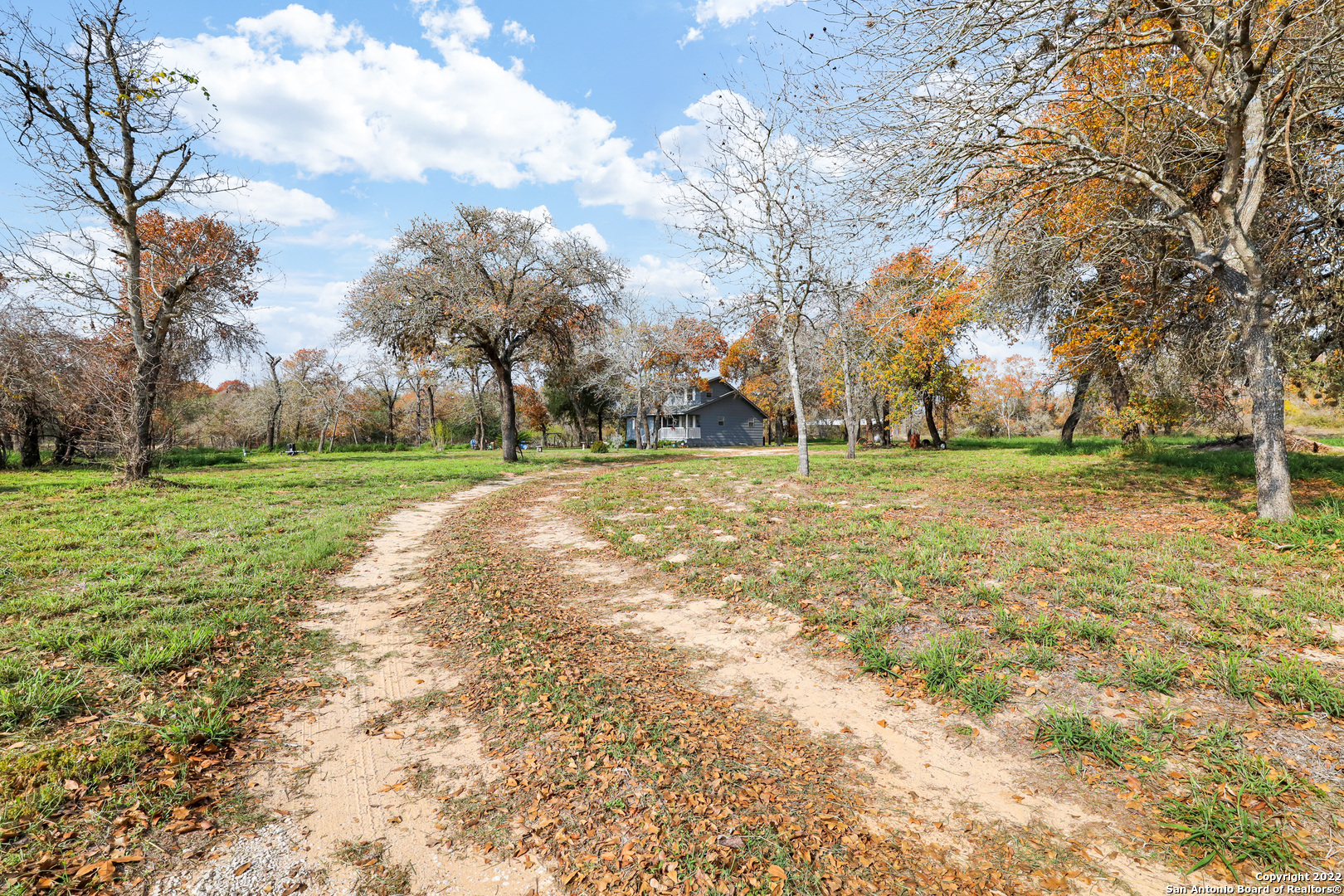 This charming 3 bedroom house sits on 7.129 acres. The main house is 1,495 sq ft with master bedroom downstairs, open living room with picture windows. Treed property has Hill Country views for your homestead or weekend retreat.