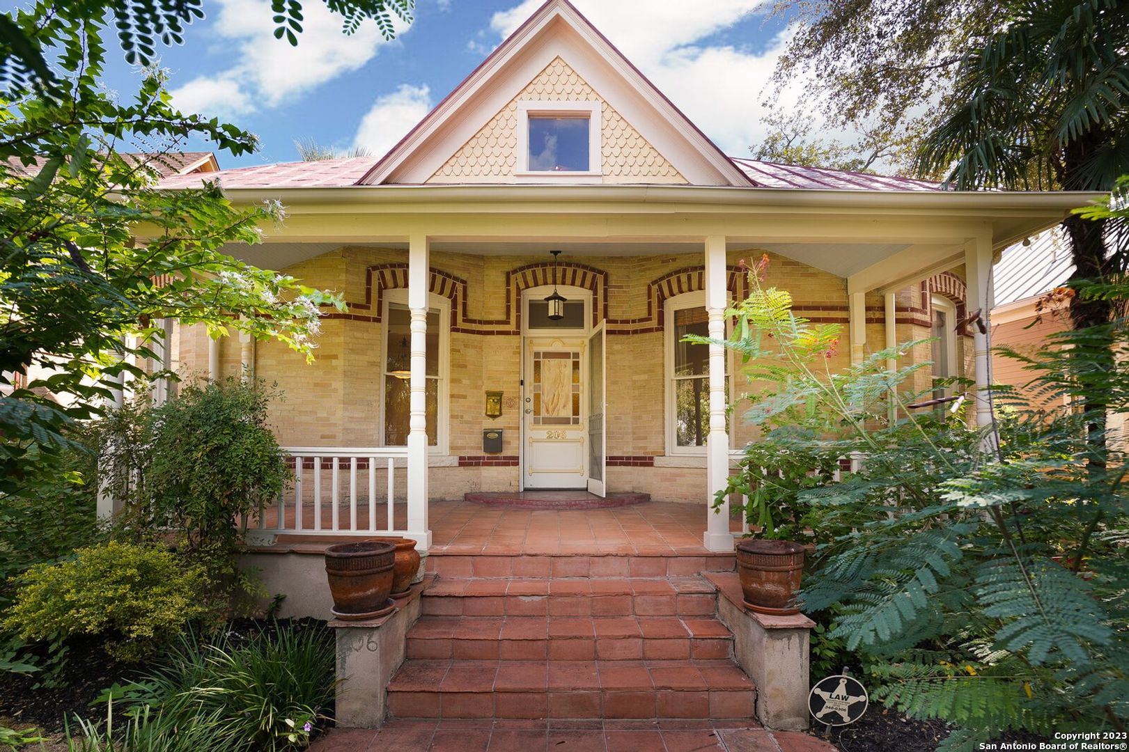 Nestled in the heart of the historic King William District, just blocks from the San Antonio River and Southtown restaurants and shops, this 1893 Victorian brick home boasts many unique features of the era. The stained-glass-accented front door with its original transom window welcomes you to an open entry way, bordered with floor-to-ceiling built-in bookcases. Gleaming, rare, long-leaf yellow pine floors throughout the first floor are the result of a recent renovation. Ultra-high ceilings, vintage molding and numerous light-filled large windows make this home warm and inviting. The updated kitchen features gas cooktop, elevated dishwasher for easy access, soapstone counter tops, custom cabinetry, and lighted hanging pot rack. A free-standing claw-foot tub, walk-in closet and glassed-in steam shower are included in the second floor en-suite, completed in 1996. The back deck and yard feature tall fences and beautiful loquat trees for privacy. One of the few homes in the area with alley access and off-street parking for entry from the rear. The two air conditioners have been replaced within the past three years along with the smart thermostats. Cast iron Hunter ceiling fans are installed in many rooms to keep the home comfortable during the warmer months. Comes with city-approved, architect-designed plans for a two-story carriage house and garage for construction off the alley. Experience the best of San Antonio in a vibrant neighborhood that offers so much being within minutes to some of the best dining, breweries, Hemisphere Park, Downtown, boutiques, Blue Star Arts Complex, Mission Reach, and Southtown.