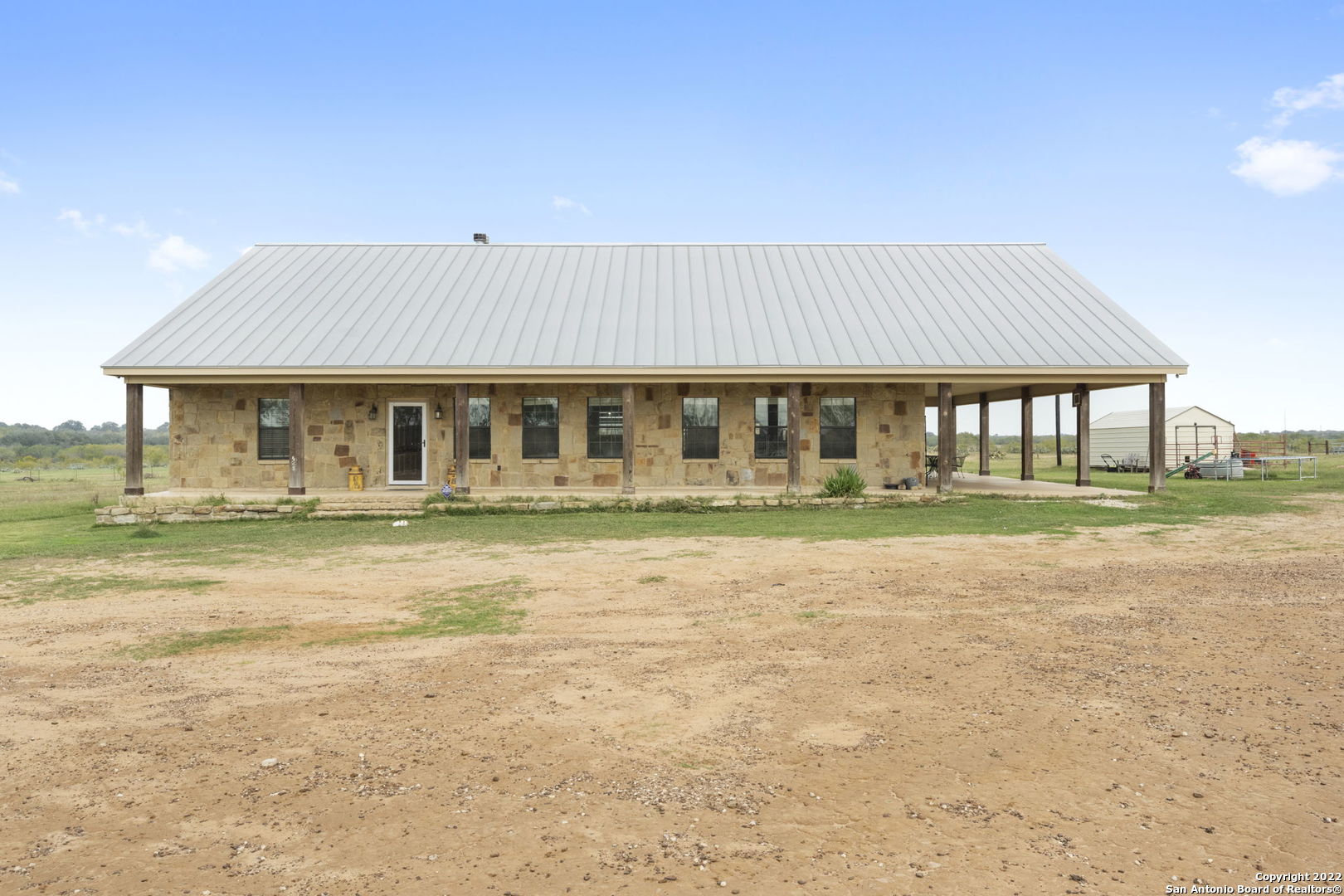 ATASCOSA COUNTY TAX# 0000900000004402.....SURVEY WITH EASEMENT ON ASSOCIATED DOCS....SO SECLUDED AND PRIVATE THIS HOME SITS OFF TANK HOLLOW ROAD DOWN IN THE BACK ON 3 ACS....ADDITIONAL 12 ACS CAN BE PURCHASED ALSO*****ROCK HOME WITH METAL ROOF*****LARGE FRONT COVERED PORCH THAT WRAPS AROUND TO THE SIDE FOR A LARGE COVERED PATIO AREA******OPEN FLOORPLAN WHEN YOU WALK IN FRONT DOOR YOU SEE HIGH CEILING WITH LARGE ISLAND KITCHEN, TONS OF CABINETS, BEAUTIFUL GRANITE.....DINING AREA INFRONT OF BEAUTIFUL ROCK FIREPLACE WITH INFLOOR PLUGS....THIS HOME HAS SO MANY OPTIONS.... 4 BEDROOM OR 5 BEDROOM...ONE OF THE BEDROOMS THAT HAS EXTERIOR DOOR CAN BE A PERFECT OFFICE OR STUDY**** 3 1/2 BATHS*****LARGE UTILTIY ROOM WITH EXTERIOR DOOR******SUNROOM OFF KITCHEN THRU FRENCH DOORS HAS BEAUTIFUL ROCK WOOD BURNING FIREPLACE****NICE SIZE BEDROOMS****MASTER BATH HAS LARGE GARDEN TUB WITH SHOWER *******GREAT WALKIN CLOSET**