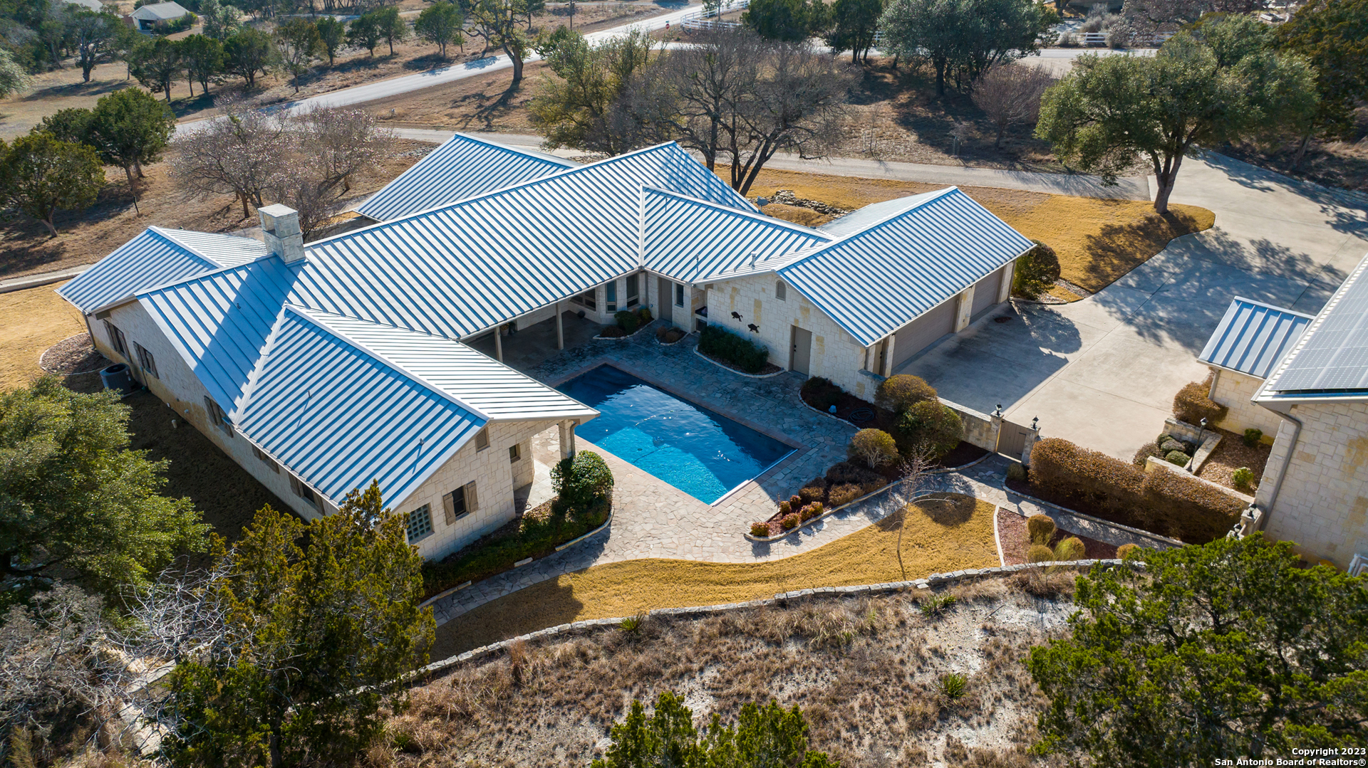 THE HORIZON - Gorgeous custom home & oversized RV barn built on 6.23 acres. Immaculately maintained w/Hill Country views, impressive open plan, high ceilings, walls of windows, built-ins, natural hardwood floors, formal dining, eat-in kitchen, island, SS apps, WI pantry, 4 beds (one currently used as media room) & office. Every corner shows attention to detail-from the airy well-appointed kitchen to designer touches on walls & ceilings. Great room w/stone masonry fireplace flanked by dbl sliding doors leading to spacious cov'd porch, pool & hot tub. Owner's suite w/dbl vanities, WI shower, lg WI closet, sitting area, hot tub/pool access & natural light. Special Features: surround sound, reverse osmosis in kitchen, pool re-surfaced in 2022, granite counters, beautiful stone accent wall, vaulted ceilings w/wood beams, exceptional outdoor living, 3-Car plus RV garage w/workshop. Lots of parking w/circ drive + driveway to garage. Gated 1066-ac community w/private roads also serves as a wildlife preserve w/Fallow Deer, Black Buck Antelope, Turkey & more roaming in a peaceful atmosphere. Hunting allowed per HOA regs. Minutes to Kerrville. L/A is daughter of seller & POA on property sale.  Buyer to purchase survey if one is needed.