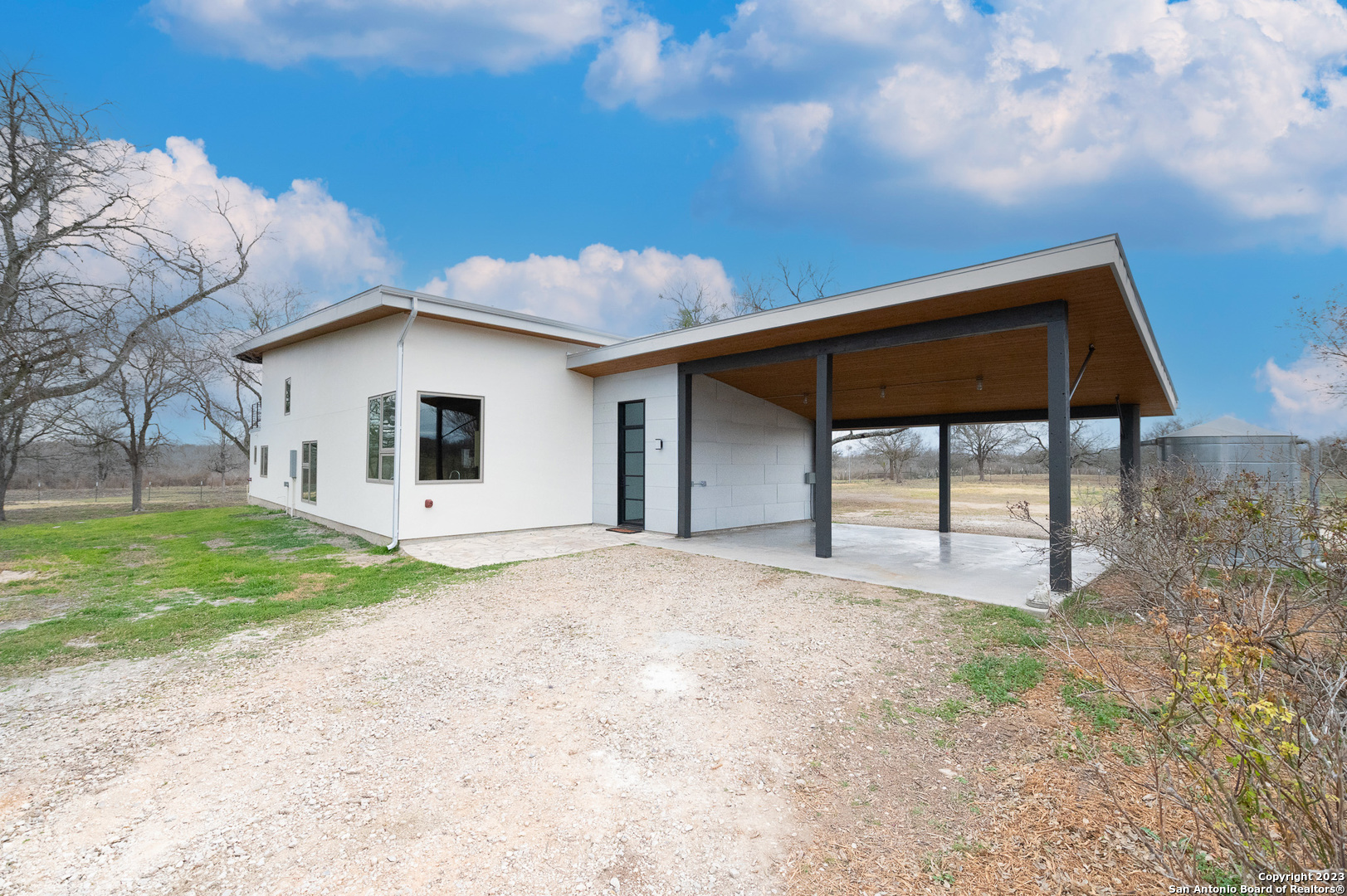 One of a kind modern home on 14 acres in MVISD. COMPLETELY REMODELED/REBUILT over the last 2 years. This 1977 sqft, 2 bed/3 bath home features an open concept living with soaring high ceilings and a loft that could be converted to 3rd bedroom if you wanted. Off the master suite is an outdoor shower, to keep the mess outside after a long day of work on the ranch! After that hard days work, enjoy the peaceful country living (minus the bugs)  on the screened in back porch. Additionally, property is fully fenced and ag-exempt with a barn and tank that owner has never seen dry! Location of this property is phenomenal, being just minutes from Castroville off of FM 1343, but with access via private lane as not to be right on the busy road. A MUST SEE!