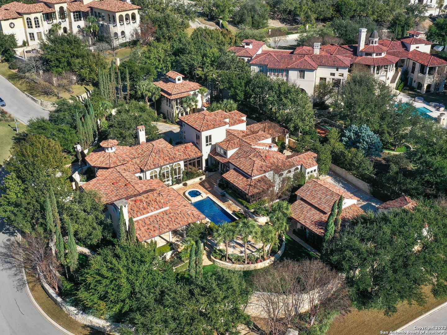 World-class grounds await hidden behind large wrought iron gates and lined with mature trees brought in to provide unrivaled levels of privacy from the road. Poised for large-scale entertaining, this palatial Mediterranean estate is nothing short of spectacular. Privately gated and secluded on a corner lot, enter through the oversized double wrought iron gate to an expansive flagstone and in-laid brick motor court with ample space for guest parking. A separate guest apartment with private access off of Crescent Park features the same level of luxurious detail to include a living room, bar, and full bath down and an oversized guest suite up with vaulted ceilings, a sitting area, and an en suite bath. Step inside and be greeted by walls of floor-to-ceiling windows allowing for natural lighting to flood the interior, affording ample opportunity to relish in the gem's extraordinary appointments. From the gourmet chef's kitchen with a large beveled bullnose eat-in granite island to the family room with hand carved Cantera fireplace, every aspect of this home is grand in scale and bold in design. Indulge in the resort-style outdoor paradise with extensive stone and brick decking and hardscaping surrounding the spectacular hand-laid mosaic glass tile pool and jacuzzi with three tiers of entertaining space. Recently re-stucco of exterior throughout and refinishing of wood floors throughout. An unrivaled opportunity to enjoy an unparalleled lifestyle of seclusion, luxurious comfort, and lavish entertaining within the coveted guarded gates of The Dominion.
