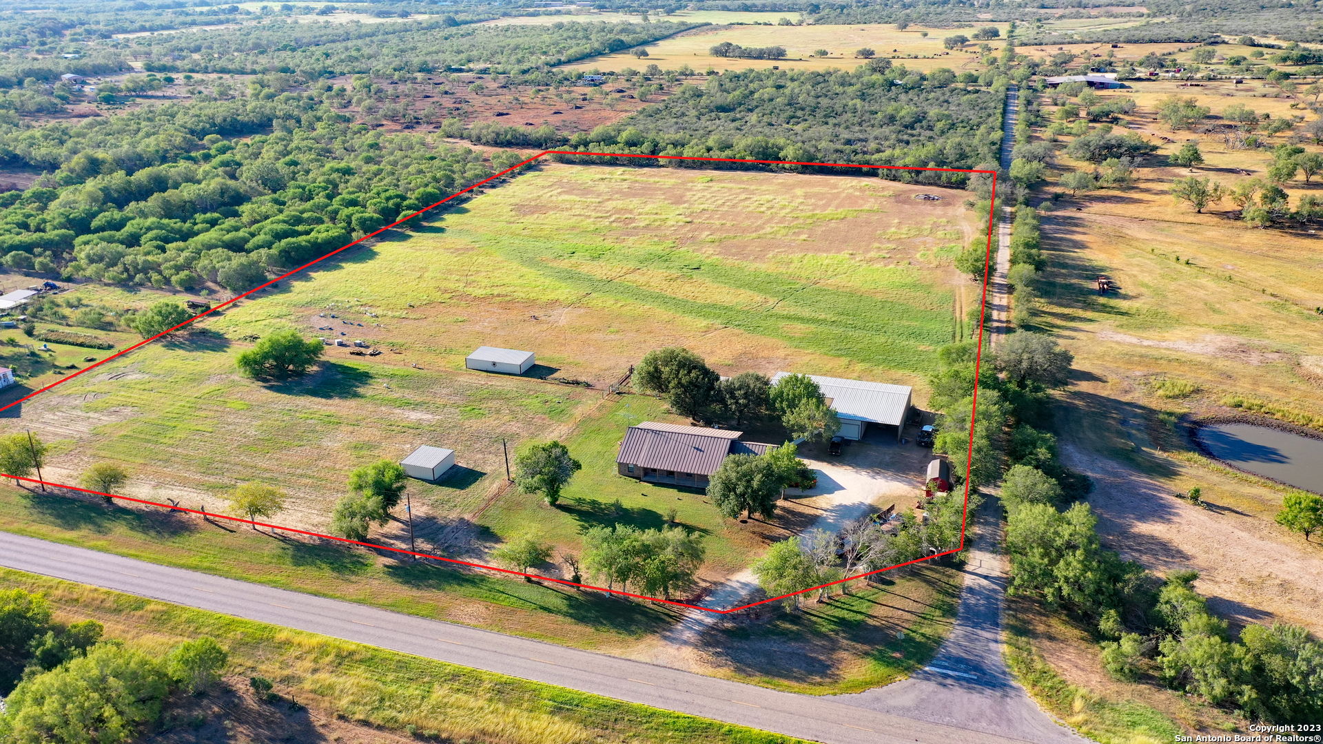 Built in 2001, this three bedroom / two bath ranch style home sits on 11.4 acres, just west of Yancey, Texas.  The 2,636-sf home has a masonry/Hardie exterior, standing seam metal roof, and an attached two car carport.  The interior of the home features an open concept kitchen/dining/living area, master-suite, study, two additional bedrooms w/shared bath, and a laundry/mud room.  Additionally, the home has large porches, front and back, with a surrounding of mature shade trees.