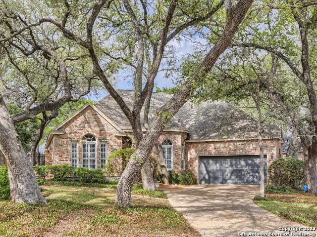 Take a look at this welcoming and eye-catching 1 1/2 story (just a flexroom upstairs) house in gated Oakwood in the NEISD school district. This house features a large family room with gas fireplace to entertain friends and family. Plantation shutters along the front of the house add to the curb appeal. The gourmet kitchen with Kitchen-aid appliances, breakfast bar and work niche offers gas cooking, plenty of hard surface counters, cabinets in the breakfast room, walk-in pantry and butlers pantry. Refrigerator is included. Step out on your covered patio and enjoy your morning coffee or afternoon cocktail.  Oversized primary suite offers outside access with ensuite including separate tub and shower, double vanity and large walk-in-closet. Separate dining room.  Two additional bedrooms with large closets, ceiling fans and a full bathroom.  The flex room upstairs can your workout room, home office, media room or gameroom. Oversized garage with extra space for storage.  Plenty of walk-in attic space for storing holiday decorations, luggage, et al. High-end ultra-efficient and allergen-effective HVAC system installed in 2020.