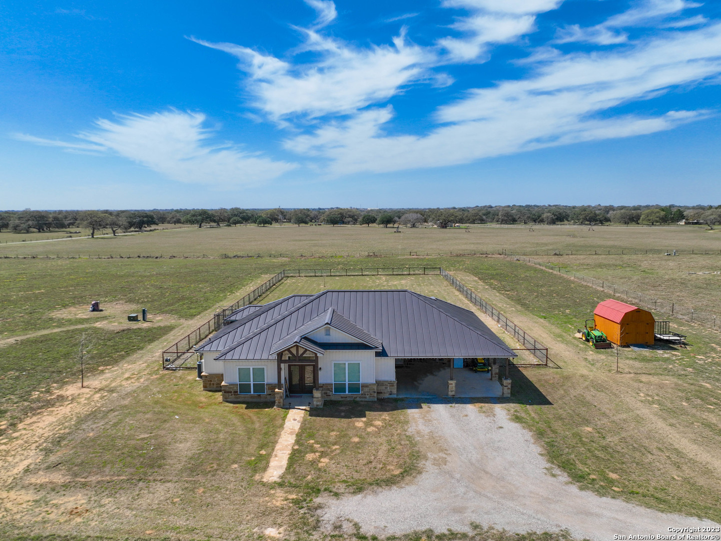 This 15 acre Atascosa County homestead is exactly what you've been looking for! This property features a 1901 square foot custom 4 bedroom and 2 bathroom home with secluded yet convenient access to Pleasanton, San Antonio as well as easy access to multiple major highways. The inside of the home features an open layout that is filled with excellent natural lighting and a split master bedroom floorplan. Raised ceilings are throughout the home along with Quartzite custom countertops in the kitchen and in the bathrooms. Behind the home features a metal fenced in back yard and a large 29'X8' back patio perfect for views of the surrounding countryside. The property features 2 water wells, perimeter fencing, and underground electric to the home. This home is move in ready, you must see this one in person!